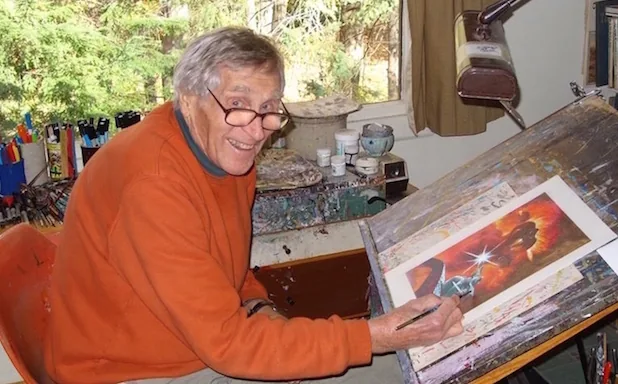 Earl Norem at his drawing board late in life, working on a painting